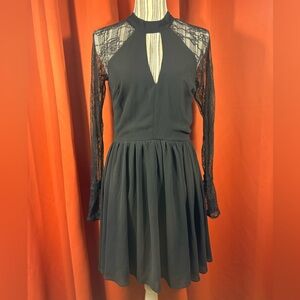 Beautiful long sleeve little black dress with lace sleeves and cut out at chest